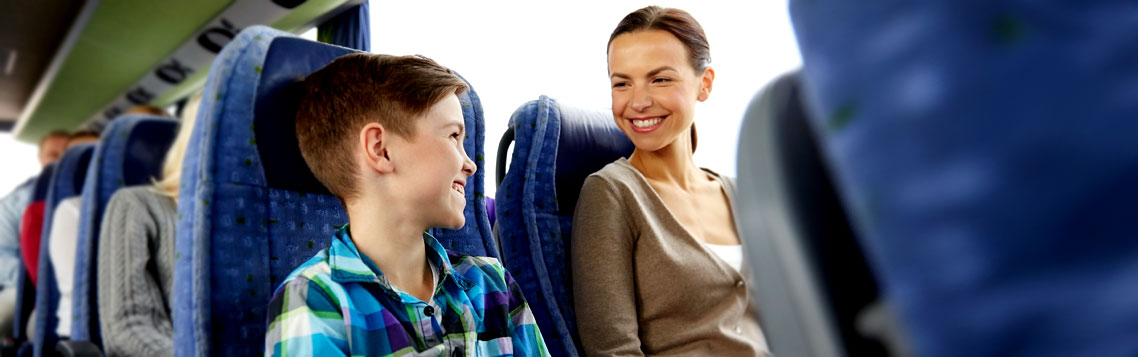 family Mother and son smiling while traveling in bus.