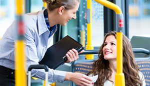 Two women talking on a bus.