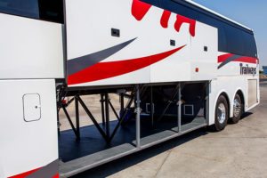 Via Adventures coach bus sides vertically open.